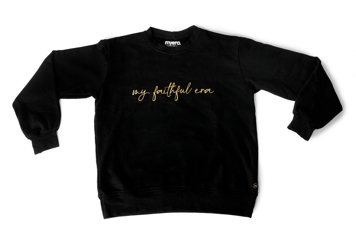 A black crewneck sweatshirt with 'my faithful era' embroidered in gold cursive across the chest, displayed flat against a white background.